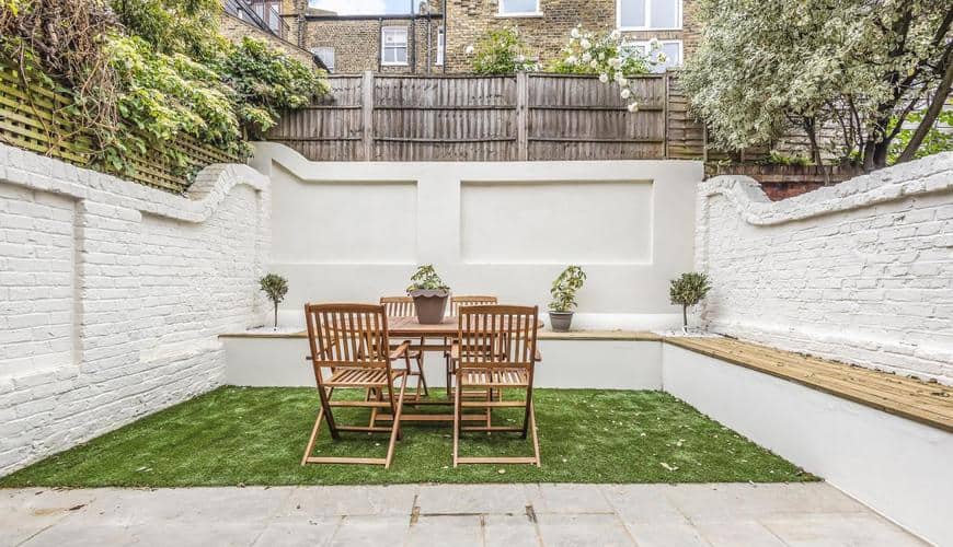 completed home extension garden white brick walls and plants
