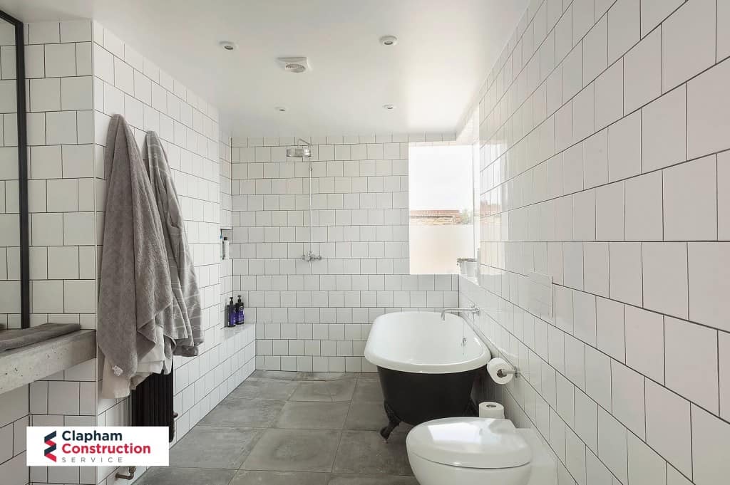 finished home extension white tiles dark bath
