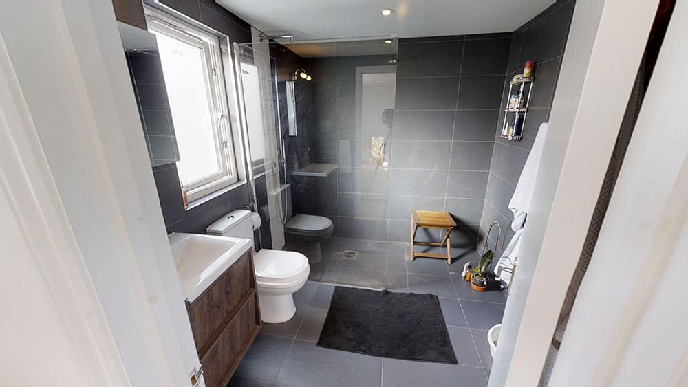 completed loft conversion bathroom black tiles