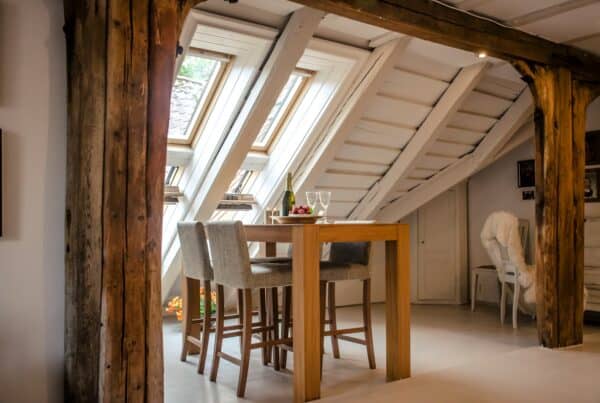 brown wooden dining table with two gray seats near opened window